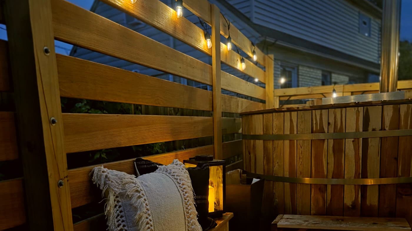 Cedar Soak hot tub deck set up at dusk with string lights